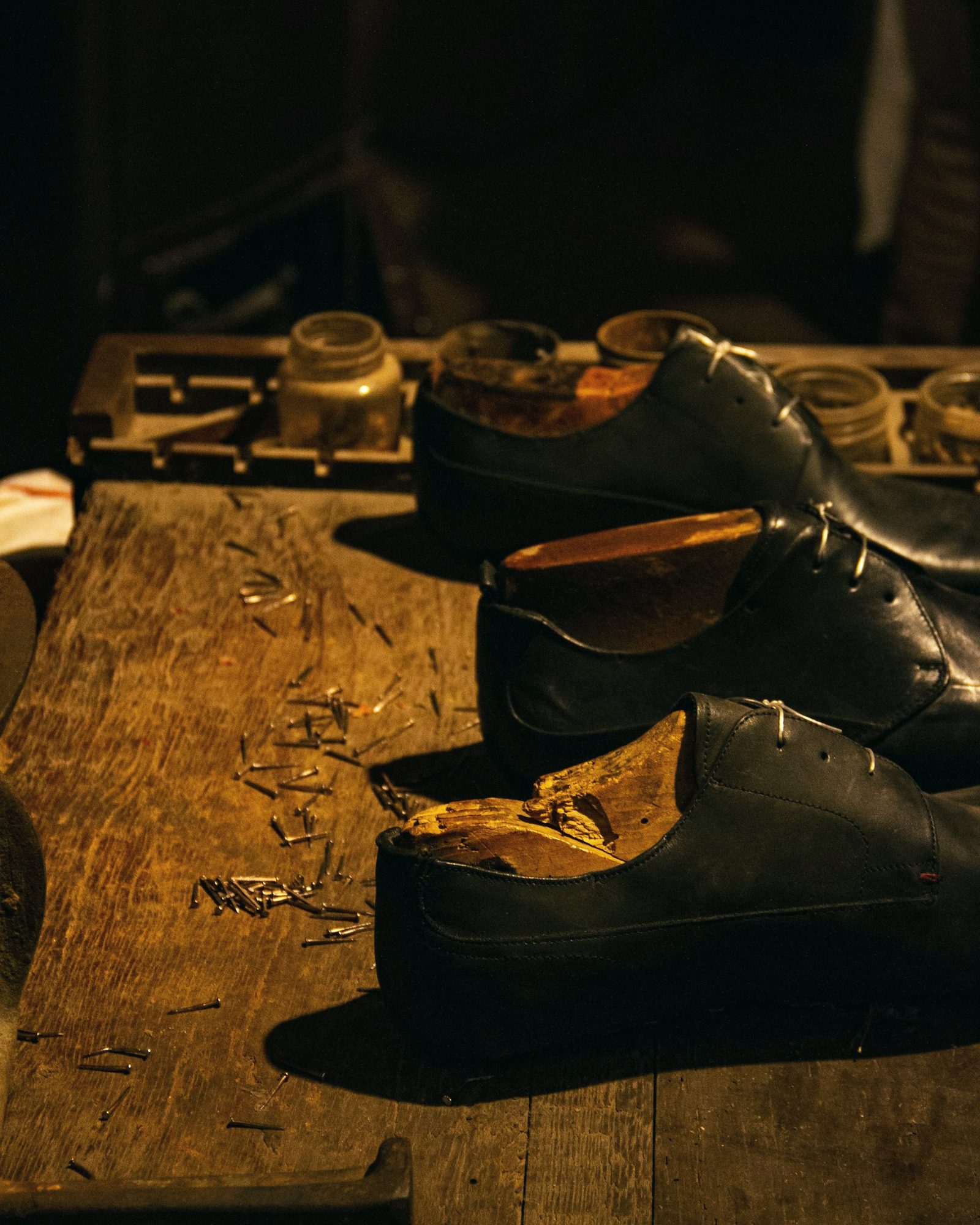 Shoes shaped on wooden lasts on a shoemaker's bench